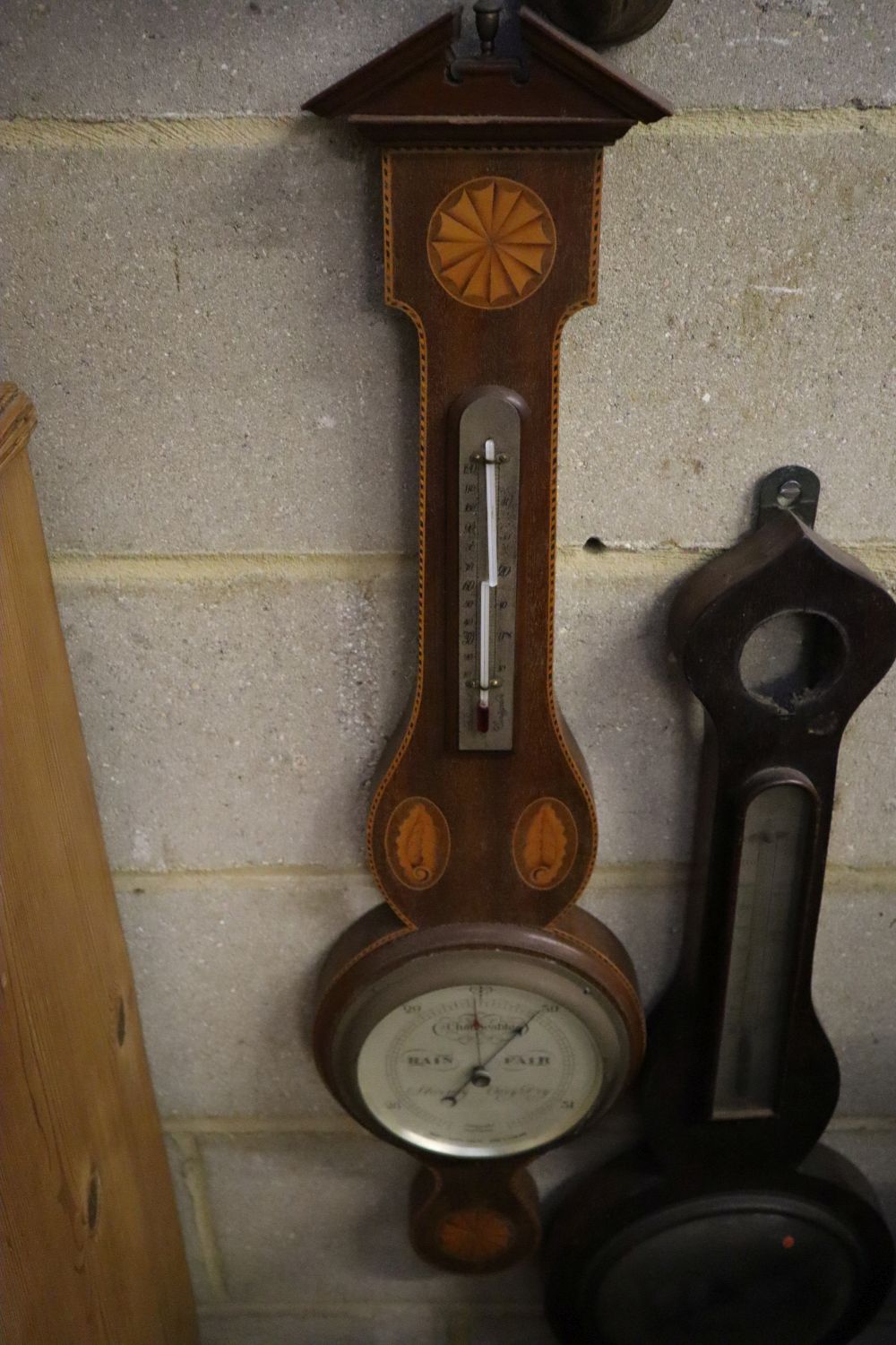 A late Victorian mirrored wall bracket and two wheel barometers
